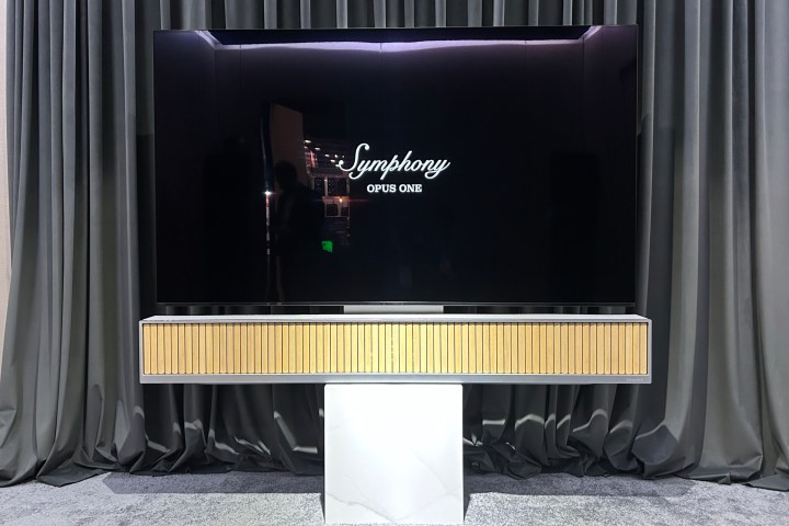 Dynaudio Symphony Opus One below an 83-inch TV.