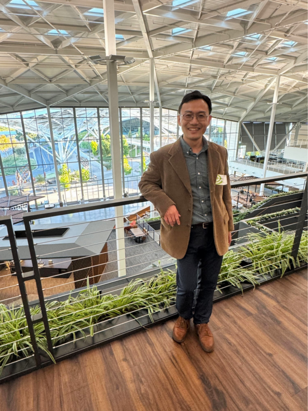 Photo of hackathon winner Feifan Liu standing inside NVIDIA headquarters.
