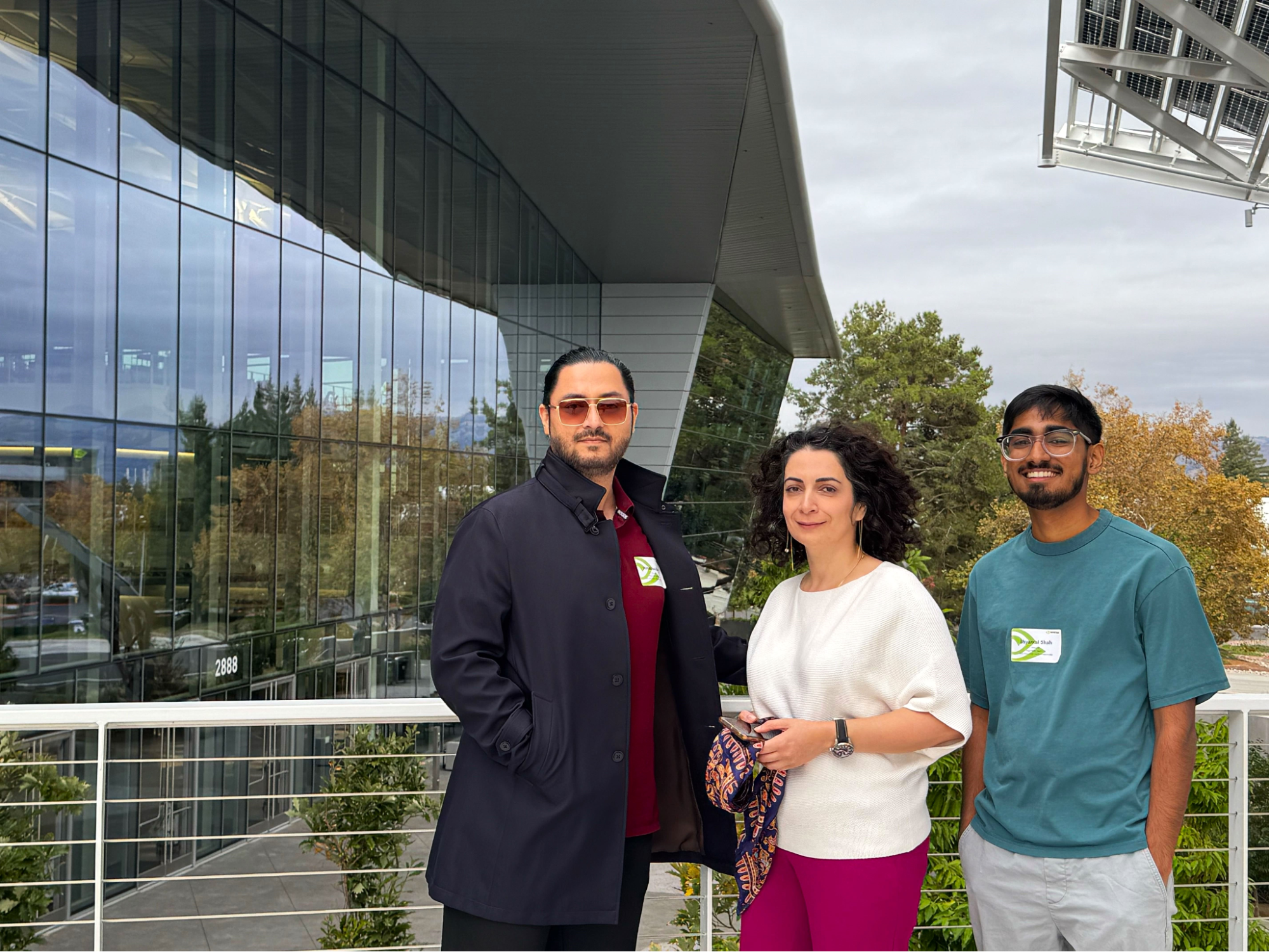 Photo of hackathon winners Himalaya Dua, Sara Zare, and Shyamal standing outside NVIDIA headquarters.
